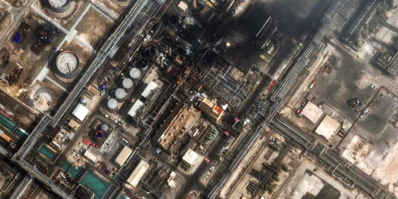 Aerial view of a Saudi oil refinery with flare stacks.